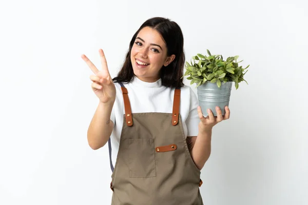 Joven Mujer Caucásica Sosteniendo Una Planta Aislada Sobre Fondo Blanco — Foto de Stock