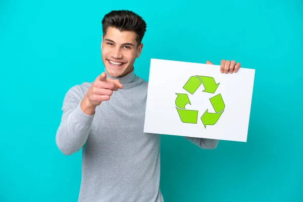 Young Handsome Caucasian Man Isolated Blue Bakcground Holding Placard Recycle — Stockfoto