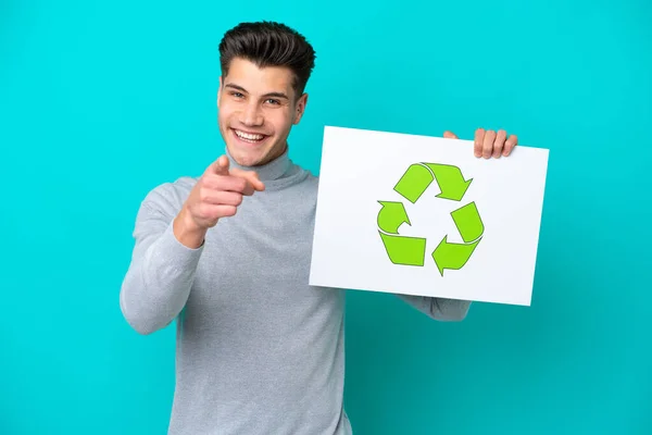 Young Handsome Caucasian Man Isolated Blue Bakcground Holding Placard Recycle —  Fotos de Stock