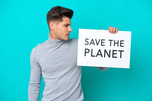 Young Handsome Caucasian Man Isolated Blue Bakcground Holding Placard Text — Fotografia de Stock