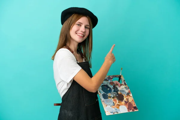 Młoda Artystka Angielski Kobieta Trzyma Paletę Odizolowanych Niebieskim Tle Wskazując — Zdjęcie stockowe