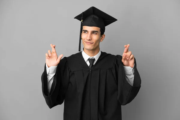 Young Argentinian University Graduate Isolated Grey Background Fingers Crossing — Stock Photo, Image