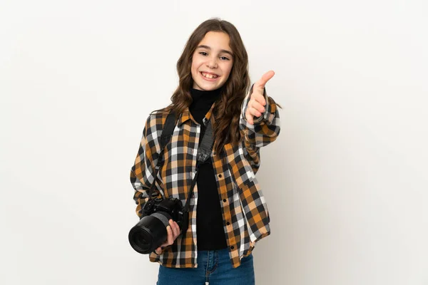 Little photographer girl isolated on background shaking hands for closing a good deal