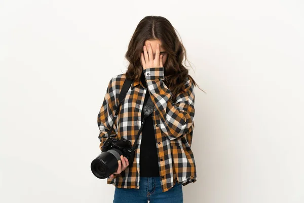 Little photographer girl isolated on background with tired and sick expression