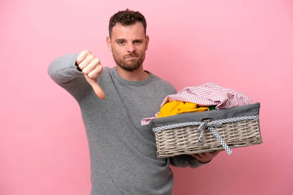 Young Brazilian Man Holding Clothes Basket Isolated Pink Background Showing — Stockfoto