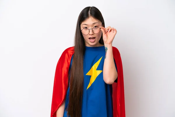 Super Hero Chinese woman isolated on white background with glasses and surprised