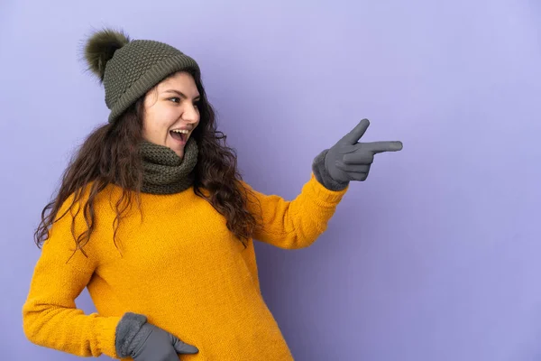 Teenager Russian Girl Winter Hat Isolated Purple Background Pointing Finger — Stockfoto