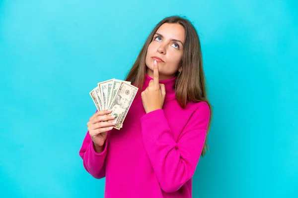 Young Caucasian Woman Taking Lot Money Isolated Blue Background Having — Foto de Stock