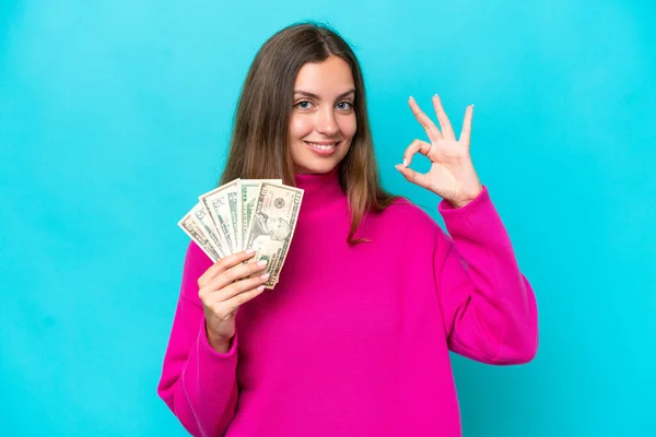 Young Caucasian Woman Taking Lot Money Isolated Blue Background Showing — Stock Photo, Image