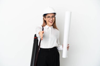 Miğferli ve elinde planları olan genç bir mimar beyaz arka planda izole edilmiş ve iyi bir anlaşma için el sıkışan bir kadın.