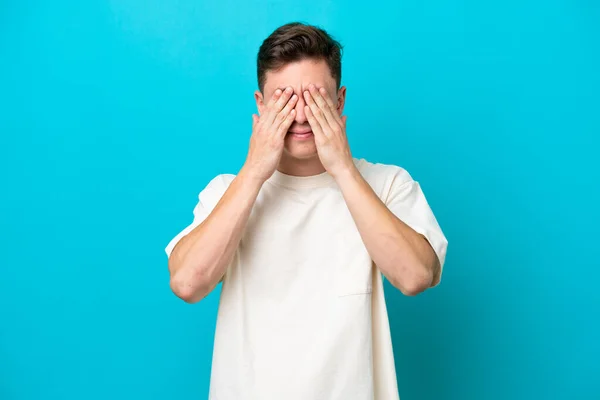 Young Handsome Brazilian Man Isolated Blue Background Covering Eyes Hands — стоковое фото