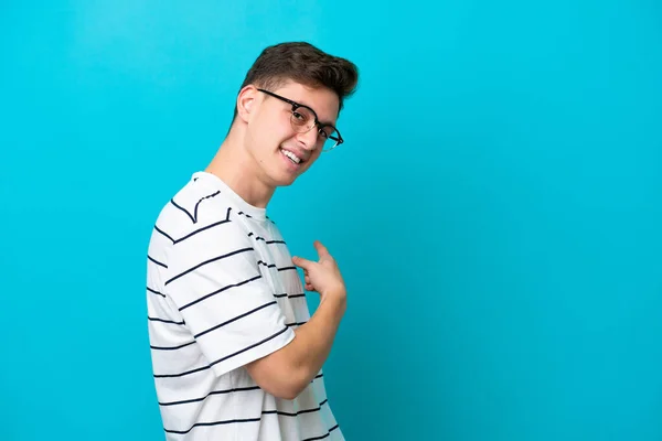 Young Handsome Brazilian Man Isolated Blue Background Pointing Back — Stock fotografie