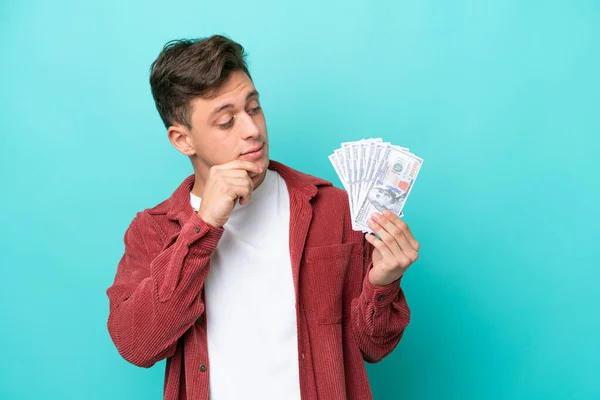 Young Brazilian Man Taking Lot Money Isolated Blue Background Looking — Stockfoto