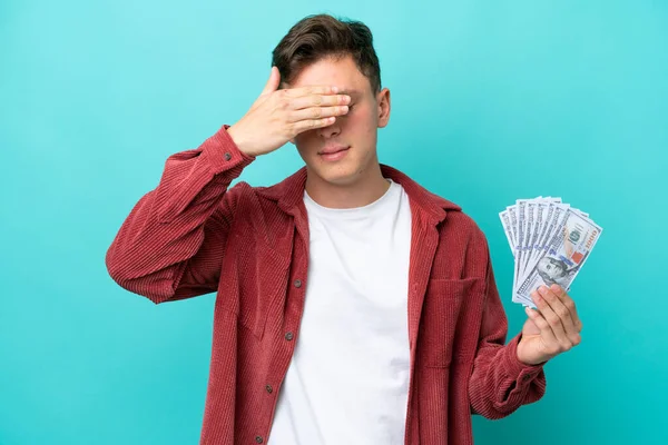 Young Brazilian Man Taking Lot Money Isolated Blue Background Covering — Φωτογραφία Αρχείου