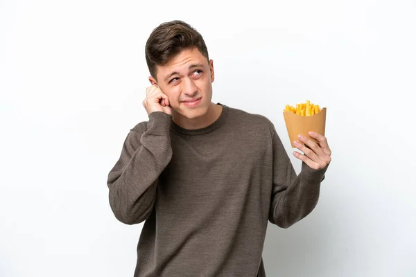 Young Brazilian Man Holding Fried Chips Isolated White Background Frustrated — Stockfoto