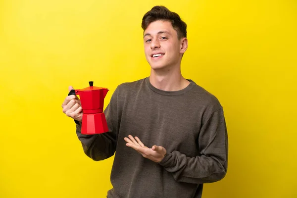 Young Brazilian Man Holding Coffee Pot Isolated Yellow Background Extending — 스톡 사진