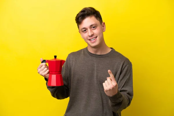 Young Brazilian Man Holding Coffee Pot Isolated Yellow Background Doing — Φωτογραφία Αρχείου