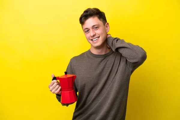 Young Brazilian Man Holding Coffee Pot Isolated Yellow Background Laughing — Φωτογραφία Αρχείου
