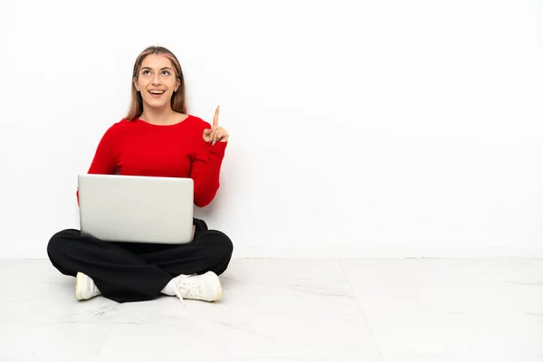 Young Caucasian Woman Laptop Sitting Floor Pointing Surprised — Stockfoto