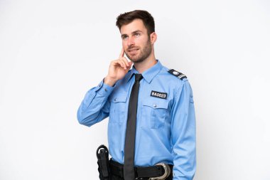 Young police caucasian man isolated on white background thinking an idea while looking up