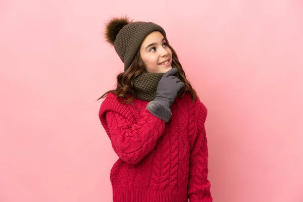 Liten Flicka Med Vinter Hatt Isolerad Rosa Bakgrund Tittar Upp — Stockfoto