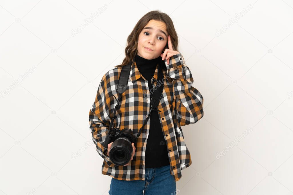 Little photographer girl isolated on background thinking an idea
