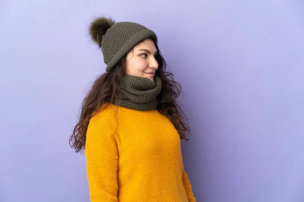 Teenager Russian Girl Winter Hat Isolated Purple Background Looking Side — Fotografia de Stock