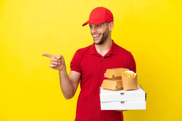 Pizza Delivery Man Picking Pizza Boxes Burgers Isolated Background Pointing — Foto de Stock
