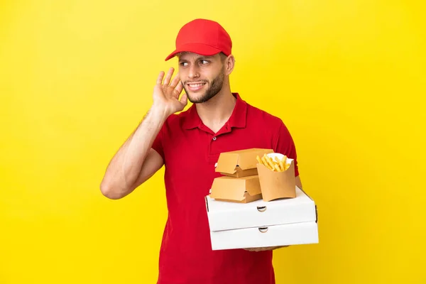 Pizza Delivery Man Picking Pizza Boxes Burgers Isolated Background Listening — Fotografia de Stock