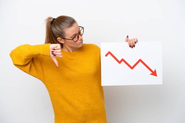 Young caucasian woman isolated on white background holding a sign with a decreasing statistics arrow symbol and doing bad signal