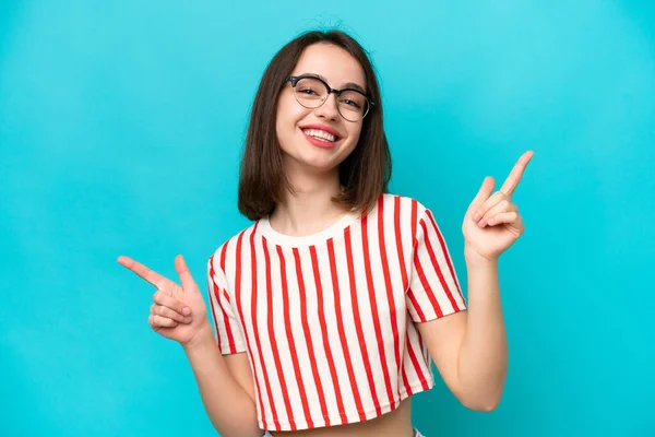 Young Ukrainian Woman Isolated Blue Background Pointing Finger Laterals Happy — Foto Stock