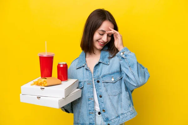 Young Ukrainian Woman Holding Fast Food Isolated Yellow Background Laughing — Stock Photo, Image