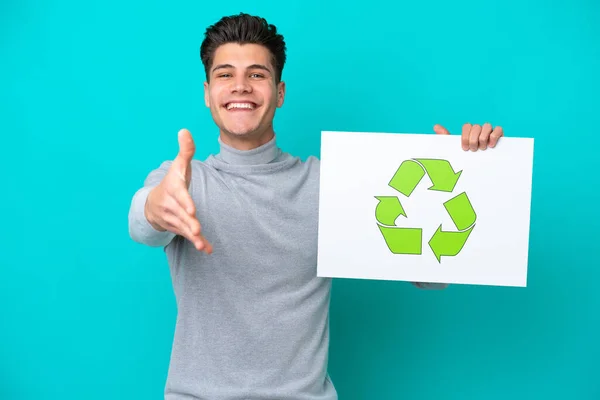 Young Handsome Caucasian Man Isolated Blue Bakcground Holding Placard Recycle —  Fotos de Stock