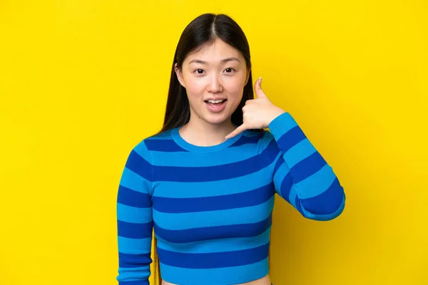Young Chinese Woman Isolated Yellow Background Making Phone Gesture Call — Foto Stock