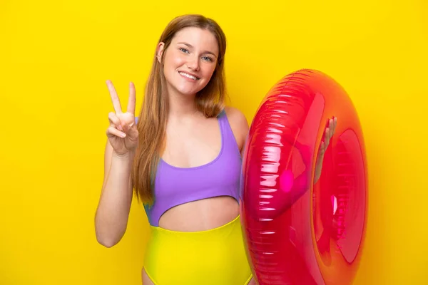 Young Caucasian Woman Holding Air Mattress Isolated Yellow Background Smiling — ストック写真