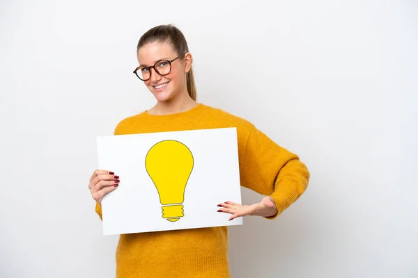 Young Caucasian Woman Isolated White Background Holding Placard Bulb Icon — Stockfoto