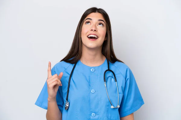 Young Brazilian Nurse Woman Isolated White Background Pointing Surprised — ストック写真