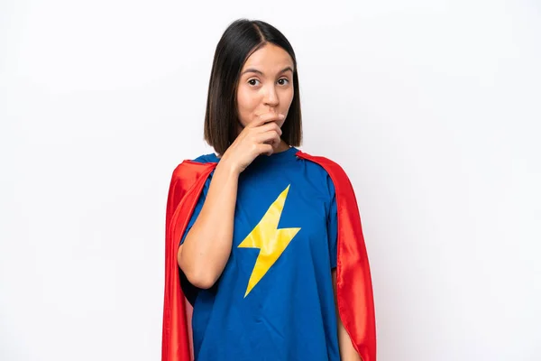 Super Hero caucasian woman isolated on white background surprised and shocked while looking right