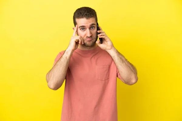 Handsome Blonde Man Using Mobile Phone Isolated Background Thinking Idea — 스톡 사진