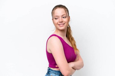 Beyaz arka planda karate yapan genç beyaz bir kız bir ürün sunmak için kenarı işaret ediyor.