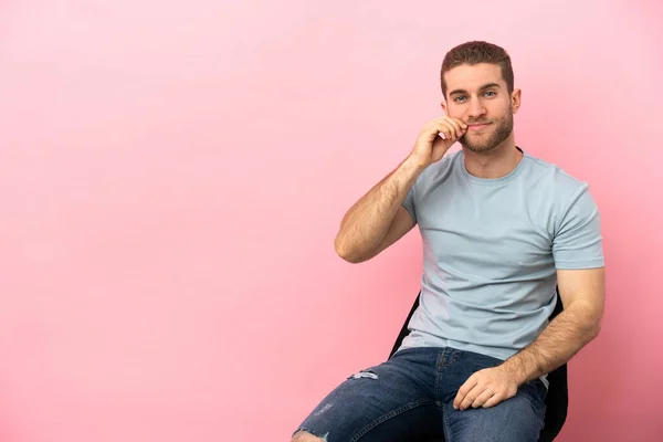 Young Man Sitting Chair Isolated Pink Background Showing Sign Silence — Stock fotografie