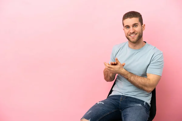 Young Man Sitting Chair Isolated Pink Background Applauding — Stock fotografie