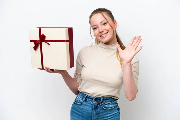 Young Caucasian Woman Holding Gift Isolated White Background Saluting Hand — 스톡 사진