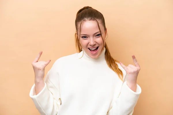 Young Caucasian Woman Isolated Beige Background Making Horn Gesture — Stock Photo, Image