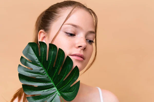 Young Caucasian Girl Isolated Beige Background Holding Palm Leaf Close — Stock Photo, Image