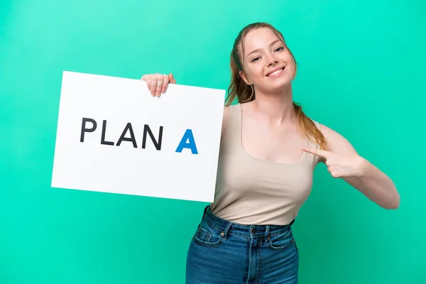 Young Caucasian Woman Isolated Green Background Holding Placard Message Plan – stockfoto