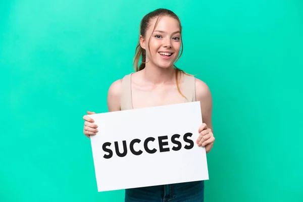 Young Caucasian Woman Isolated Green Background Holding Placard Text Success — Zdjęcie stockowe