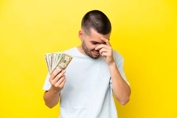 Jonge Kaukasische Man Neemt Veel Geld Geïsoleerd Gele Achtergrond Lachen — Stockfoto