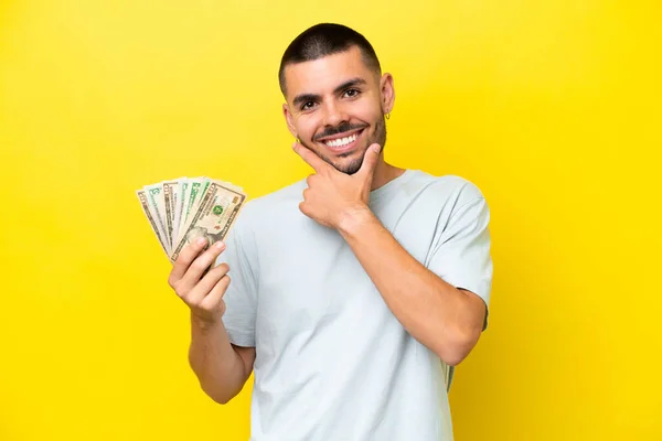 Young Caucasian Man Taking Lot Money Isolated Yellow Background Happy — Photo