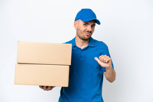 Delivery caucasian man isolated on white background proud and self-satisfied